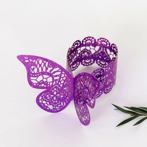 Detail of laser cut purple butterfly napkin ring with intricate hollowed out floral patterns