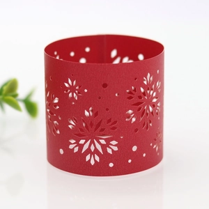 Macro detail of red laser-cut snowflake paper napkin ring for Christmas table decor