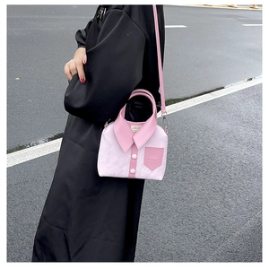 Detail view of a creative shirt-style crossbody bag with pink collar and button design