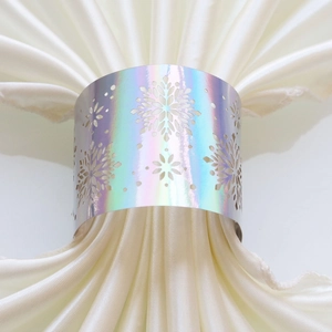 Detail of laser-cut iridescent snowflake napkin ring with holographic rainbow finish