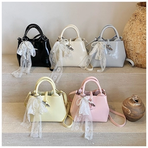 Detail showing five PU leather bucket bags with pearl bow charms and bamboo buckles