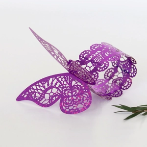 Detail of laser-cut purple glitter butterfly napkin ring for wedding and party decor