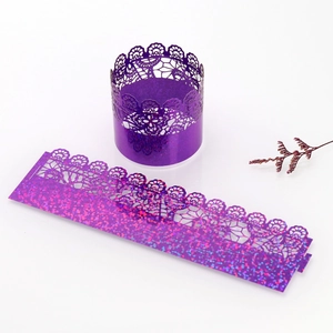 Macro shot of purple laser-cut cupcake wrapper with glitter finish and lace pattern