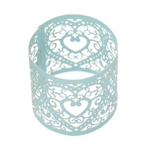 Detail of light blue laser-cut paper napkin ring with intricate heart and floral patterns
