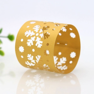 Detail of golden laser-cut snowflake paper napkin ring with elegant mirror finish