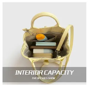 Top view of yellow woven bucket bag showing interior space with phone and cosmetics