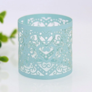 Macro detail of laser-cut light blue paper napkin ring with elegant heart pattern
