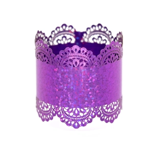Macro shot of purple holographic laser-cut napkin ring with elegant lace patterns