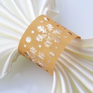 Detailed view of golden snowflake napkin ring crafted from glittery pearlescent paper