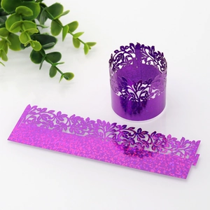 Close-up of glitter purple laser-cut flower cupcake wrappers for wedding and party decor
