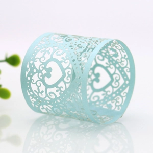 Detail of light blue laser-cut heart pattern napkin ring for elegant table decor