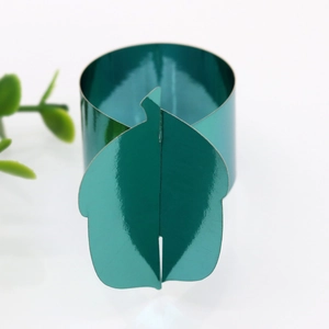 Close-up of metallic green pumpkin napkin ring with a reflective finish for party decor