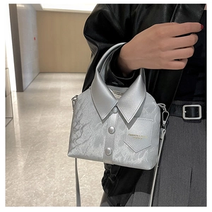 Detail of silver shirt-shaped handbag with textured leather and button accents