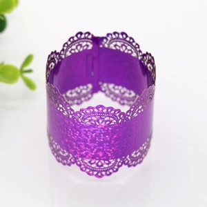 Close-up of purple laser-cut lace napkin ring with shimmer for wedding decorations
