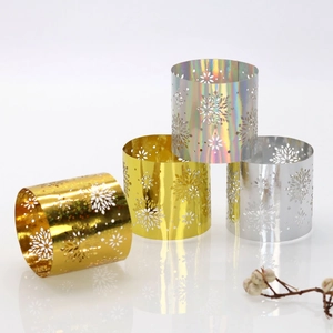 Macro detail of metallic snowflake napkin rings in gold, silver and laser finish
