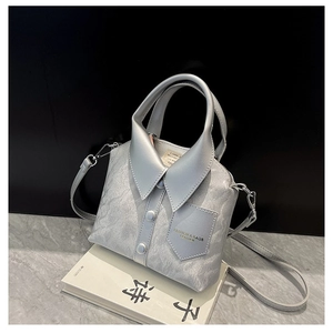 Detail of grey shirt-inspired leather handbag with collar design and silver buttons