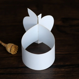 Macro view of white paper napkin rings in apple shape with minimalist 3D plug-in design
