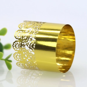 Macro shot of gold mirror napkin ring with laser-cut lace floral pattern details