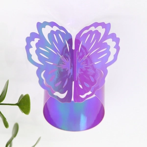 Detailed view of iridescent butterfly napkin rings with laser-cut hollow pattern