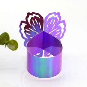 Detail of laser-cut iridescent butterfly napkin ring with holographic finish for weddings