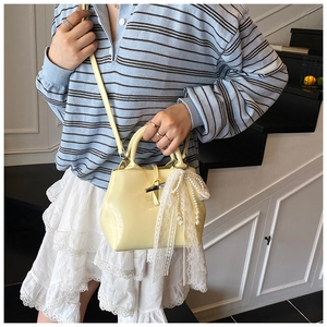 Light yellow glossy leather tote bag with lace pearl bow and bamboo metal lock detail