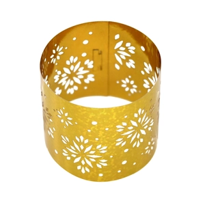 Macro detail of golden snowflake hollow metal napkin ring with pearlescent finish