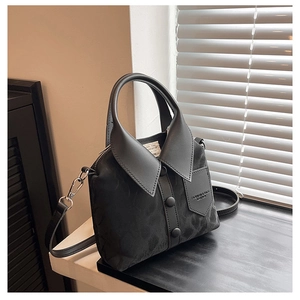 Black velvet handbag with shirt collar design and buttons showing texture and shadow