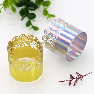 Close-up of golden and holographic crown lace laser-cut napkin rings for party decor