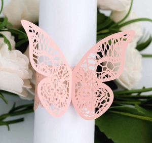 Detailed laser-cut butterfly napkin ring in pink paper for wedding table decor