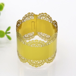 Detailed view of golden laser-cut lace napkin ring for wedding and holiday banquets