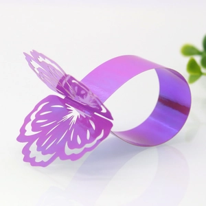 Close-up of purple laser-cut butterfly napkin ring with reflective mirror finish