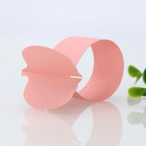 Detailed macro view of pink butterfly paper napkin ring for elegant wedding decor