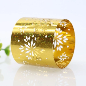 Detailed close-up of golden laser-cut snowflake napkin ring with shimmering glitter finish