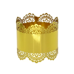 Detail showing golden laser-cut lace napkin ring with intricate hollow floral patterns