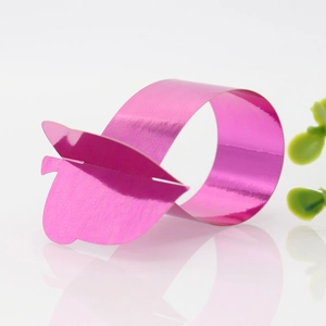 Detail of pink-purple butterfly napkin ring with metallic mirror finish for festive decor