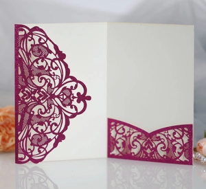 Detailed laser-cut magenta glitter cardstock wedding invitation with floral vine patterns