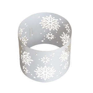 Macro detail of white laser-cut snowflake napkin ring for Christmas table decor