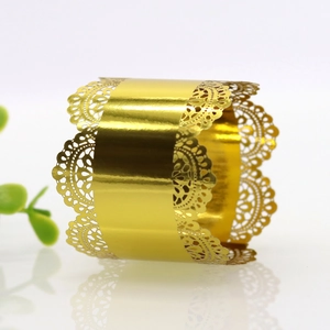 Close-up of golden hollow lace napkin ring with laser cut details and mirror finish