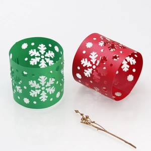 Detailed laser-cut snowflake patterns on red and green paper Christmas napkin rings
