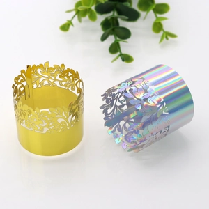 Macro shot of laser-cut gold leaf napkin rings and iridescent decorative wraps