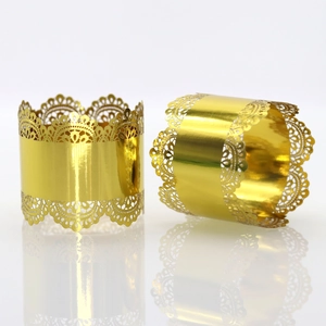 Macro detail of golden filigree hollow napkin rings for elegant wedding table settings