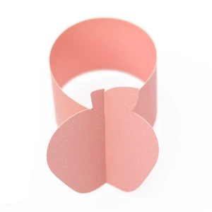 Macro view of a 3D pink paper apple napkin ring with textured finish for dining tables