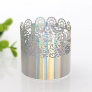 Detail of laser hollow lace napkin ring with iridescent rainbow finish on white background