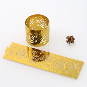 Macro view of gold snowflake napkin rings featuring hollowed-out glitter texture