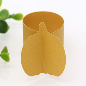 Detailed view of a shiny gold pumpkin-shaped napkin ring for Thanksgiving table decor