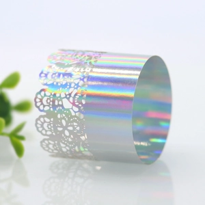 Macro view of holographic laser cut lace napkin ring with iridescent silver finish
