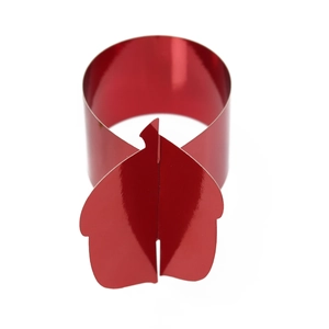 Macro shot of vibrant red metallic napkin ring with leaf-shaped clasp for party table