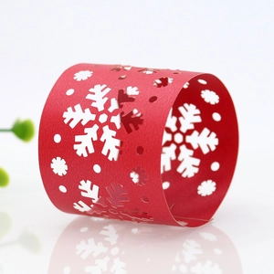 Detail of red hollowed-out snowflake paper napkin ring for Christmas holiday table decor