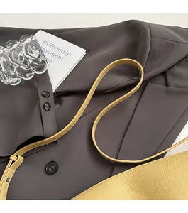 Detail of soft yellow leather dumpling bag featuring adjustable荔枝纹 textured shoulder strap