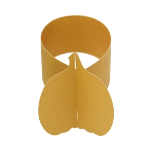 Close-up of golden pumpkin shaped napkin ring with a polished mirror finish for Thanksgiving
